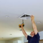 Technician-closing-vent-of-central-heating-system